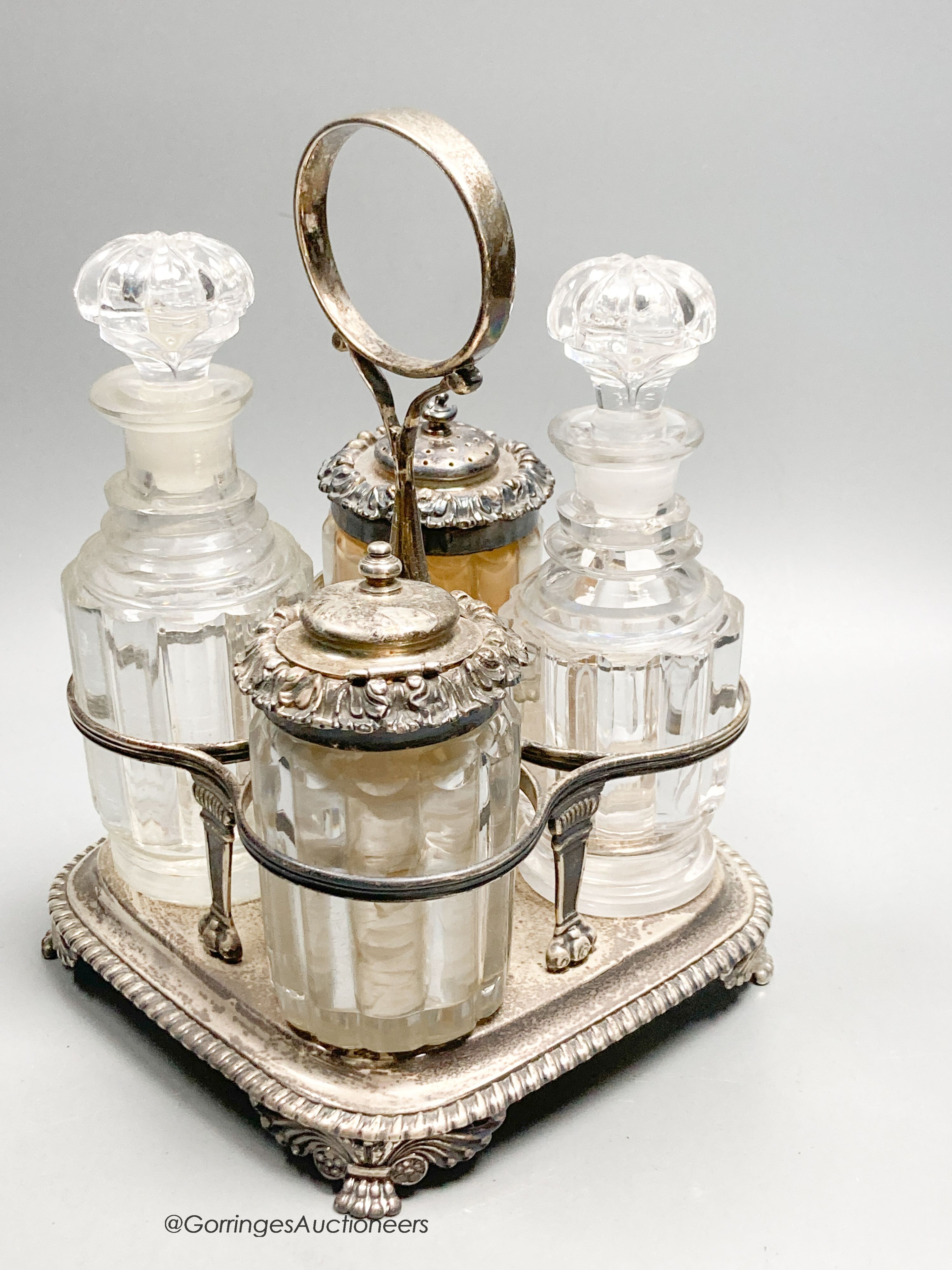 A George III silver cruet stand, by Emes & Barnard, London, 1813 and four associated cruets, two with silver mounts, 21.5cm, 13.5oz.